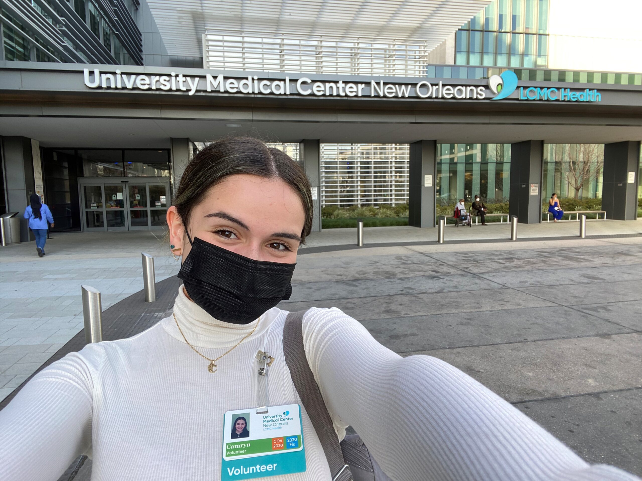 Camryn Vader standing in front of University Medical Center before volunteer shift