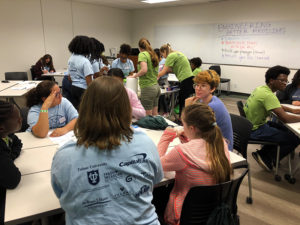 Girls participating in hands-on workshop led by GC Scholars at GiST